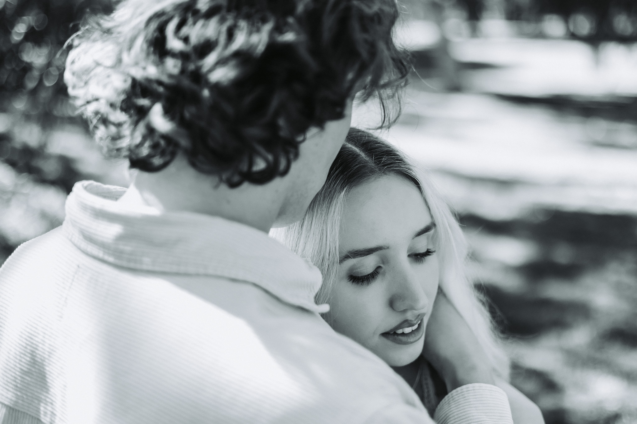 Black and white close-up of a couple in a tender outdoor embrace